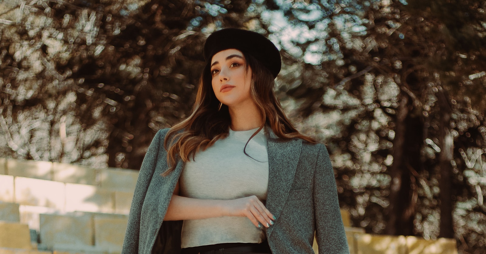 woman in gray cardigan and black hat